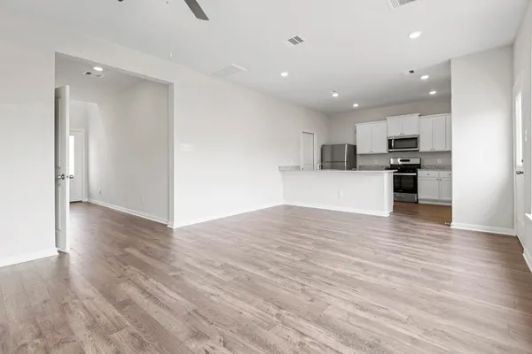 a kitchen with granite countertop a sink cabinets stainless steel appliances and a counter space