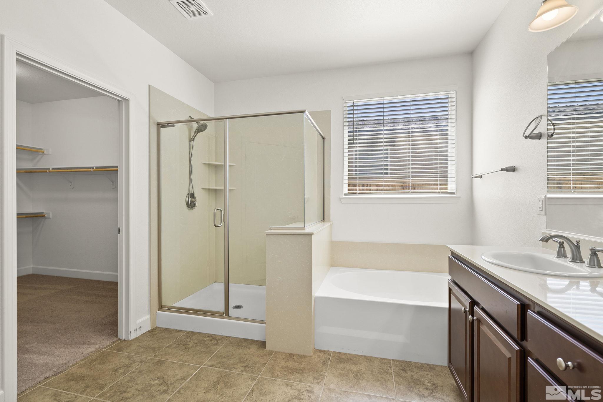 7360 Continuum Drive Reno, NV 89506 - Photo 19 of 28 a bathroom with a tub shower and sink