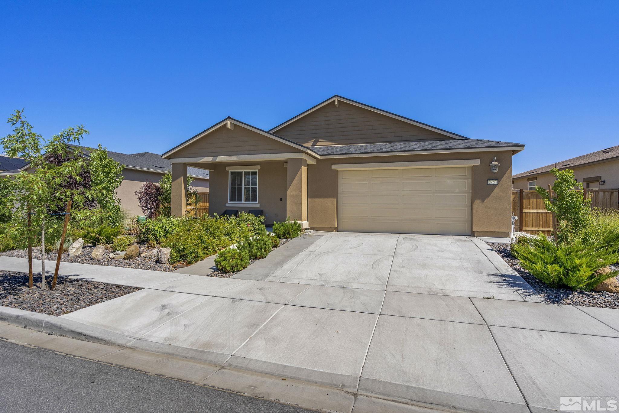 7360 Continuum Drive Reno, NV 89506 - Photo 2 of 28 a front view of a house with a yard