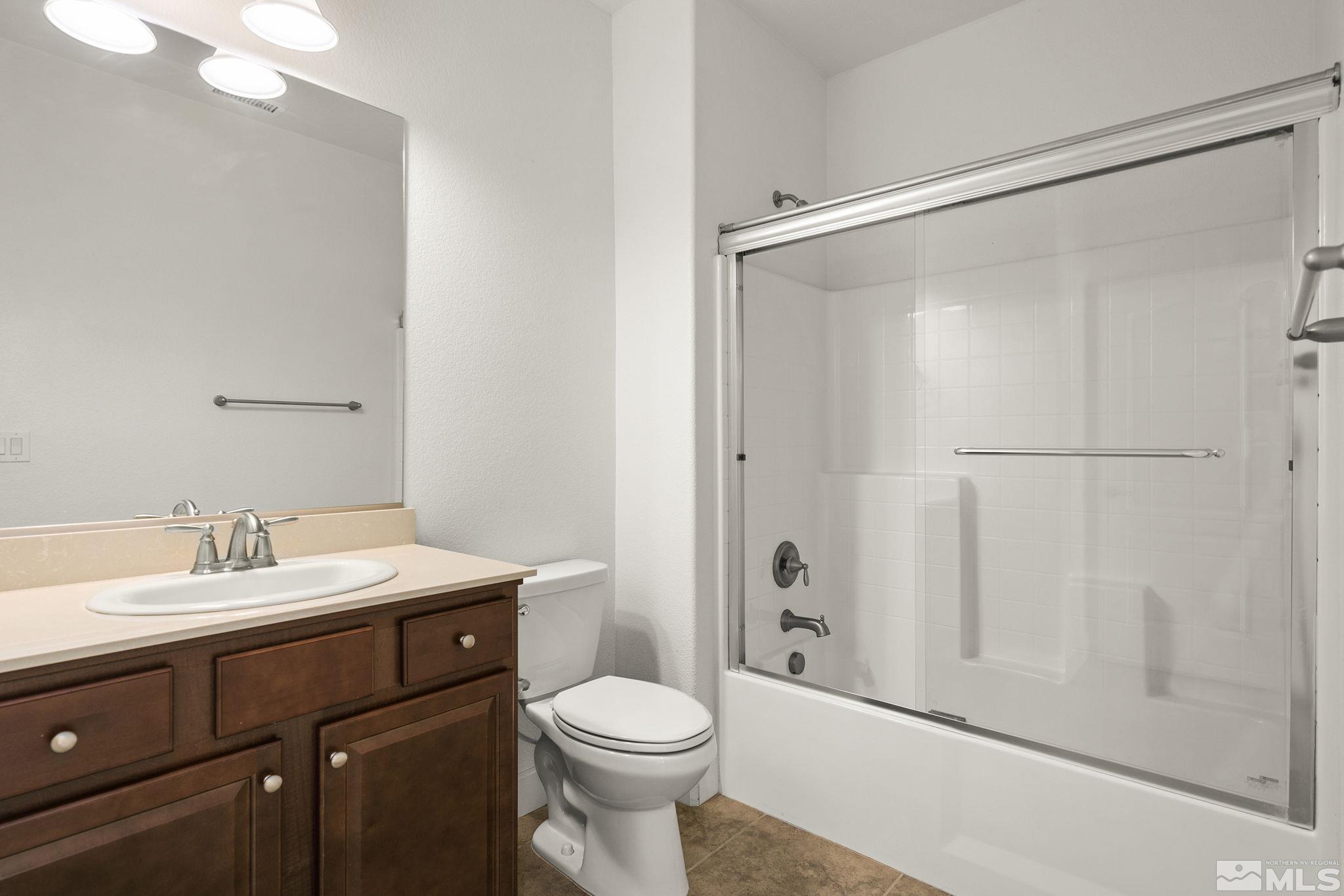 7360 Continuum Drive Reno, NV 89506 - Photo 23 of 28 a bathroom with a sink a toilet and shower