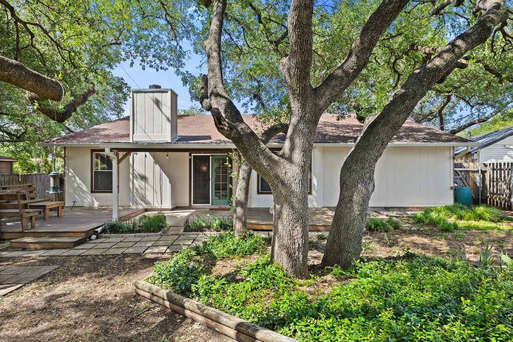 4526 Langtry Lane Austin, TX 78749 - Photo 32 of 33 Wood deck extends into the backyard, shaded by mature Live Oaks