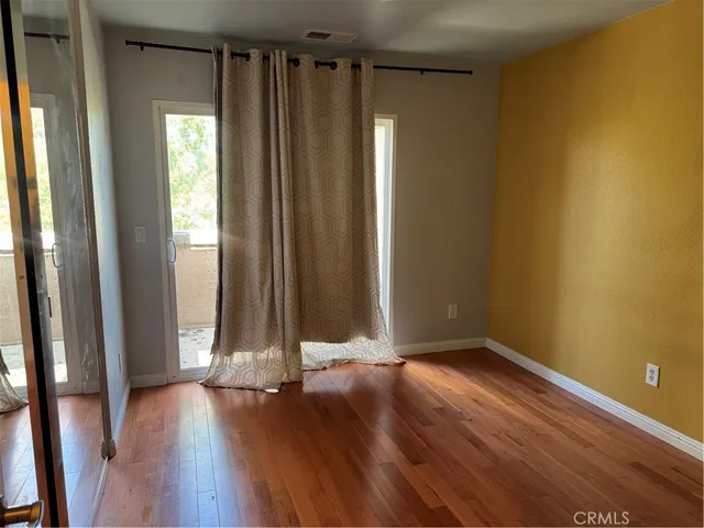 a view of room with wooden floor