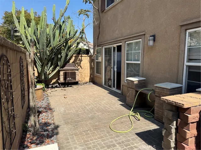 a view of a chairs and table in backyard of the house