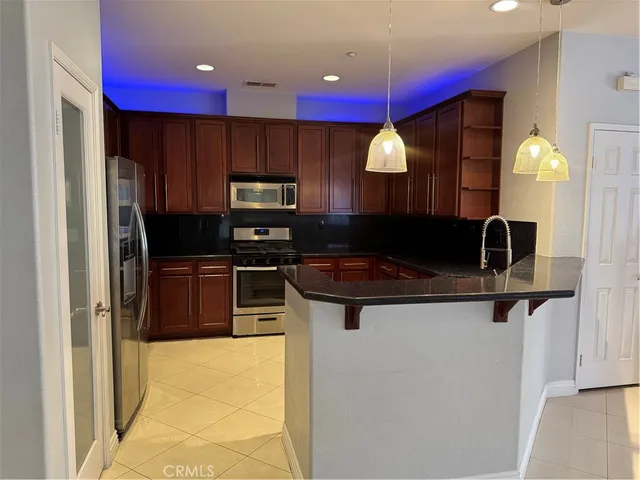 a kitchen with a sink and a refrigerator
