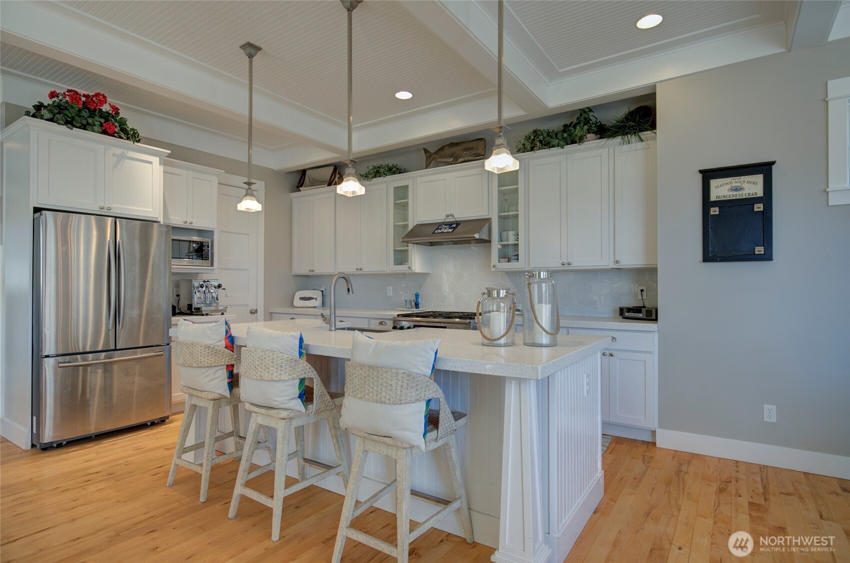 33 Fireside Lane Pacific Beach, WA 98571 - Photo 11 of 40 a kitchen with a sink a refrigerator and chairs