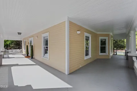 a view of a big room with balcony and windows