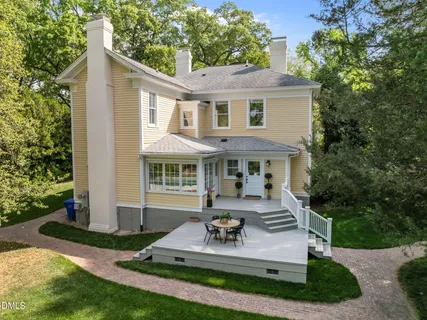 a front view of a house with yard and green space