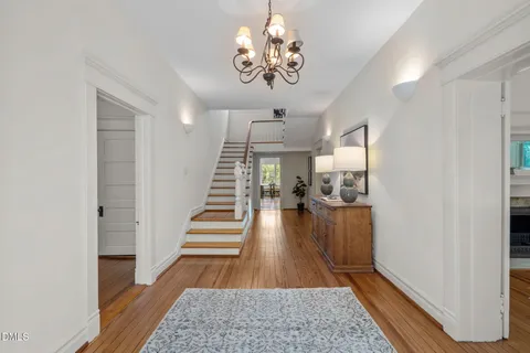 a view of entryway and hall with wooden floor