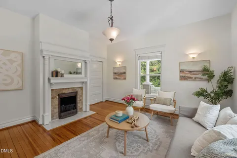 a living room with furniture a fireplace and a table