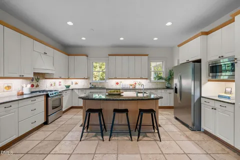 a room with furniture a large window and a sink