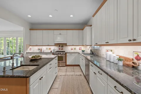 a kitchen with stainless steel appliances a refrigerator and a stove top oven