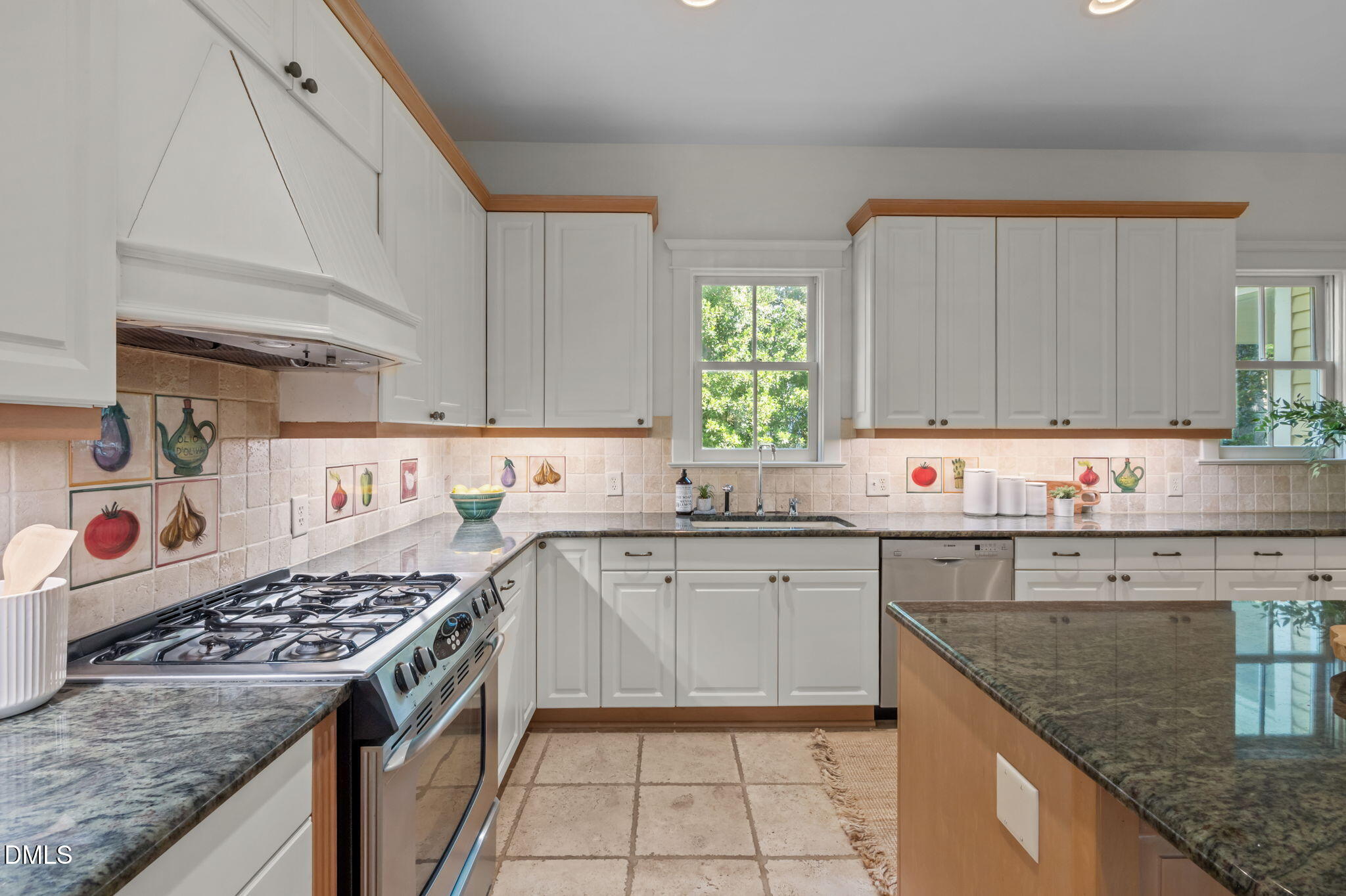 400 Ransom Street Chapel Hill, NC 27516 - Photo 29 of 67 a kitchen with kitchen island a sink stove top oven and cabinets