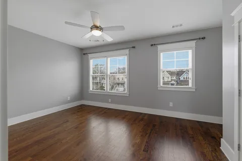 a view of wooden floor and windows in a room