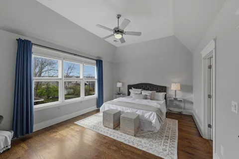 a bedroom with a bed and a large window