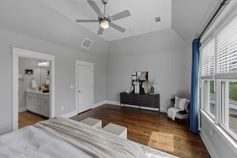 a bedroom with a bed and wooden floor