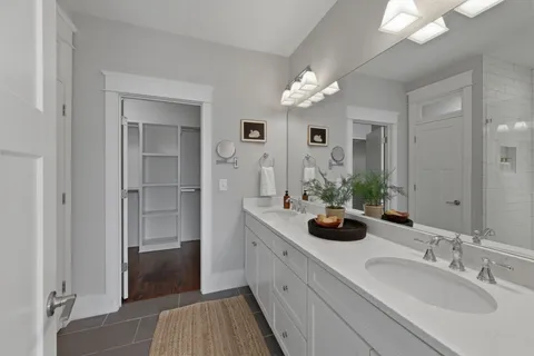 a bathroom with a double vanity sink and a mirror