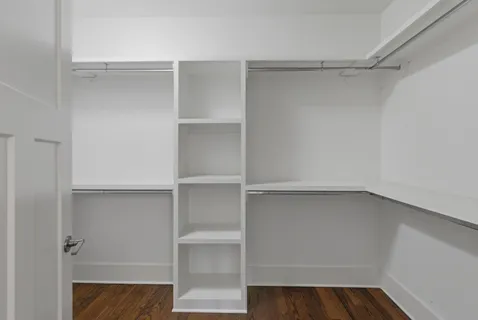 a view of walk in closet with empty racks