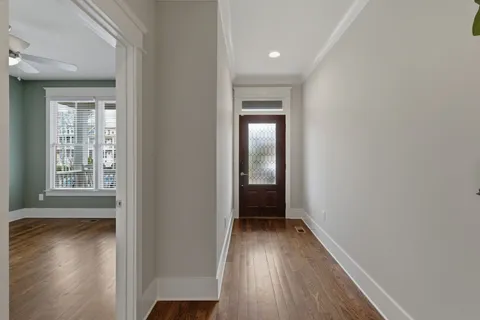a view of hallway with wooden floor