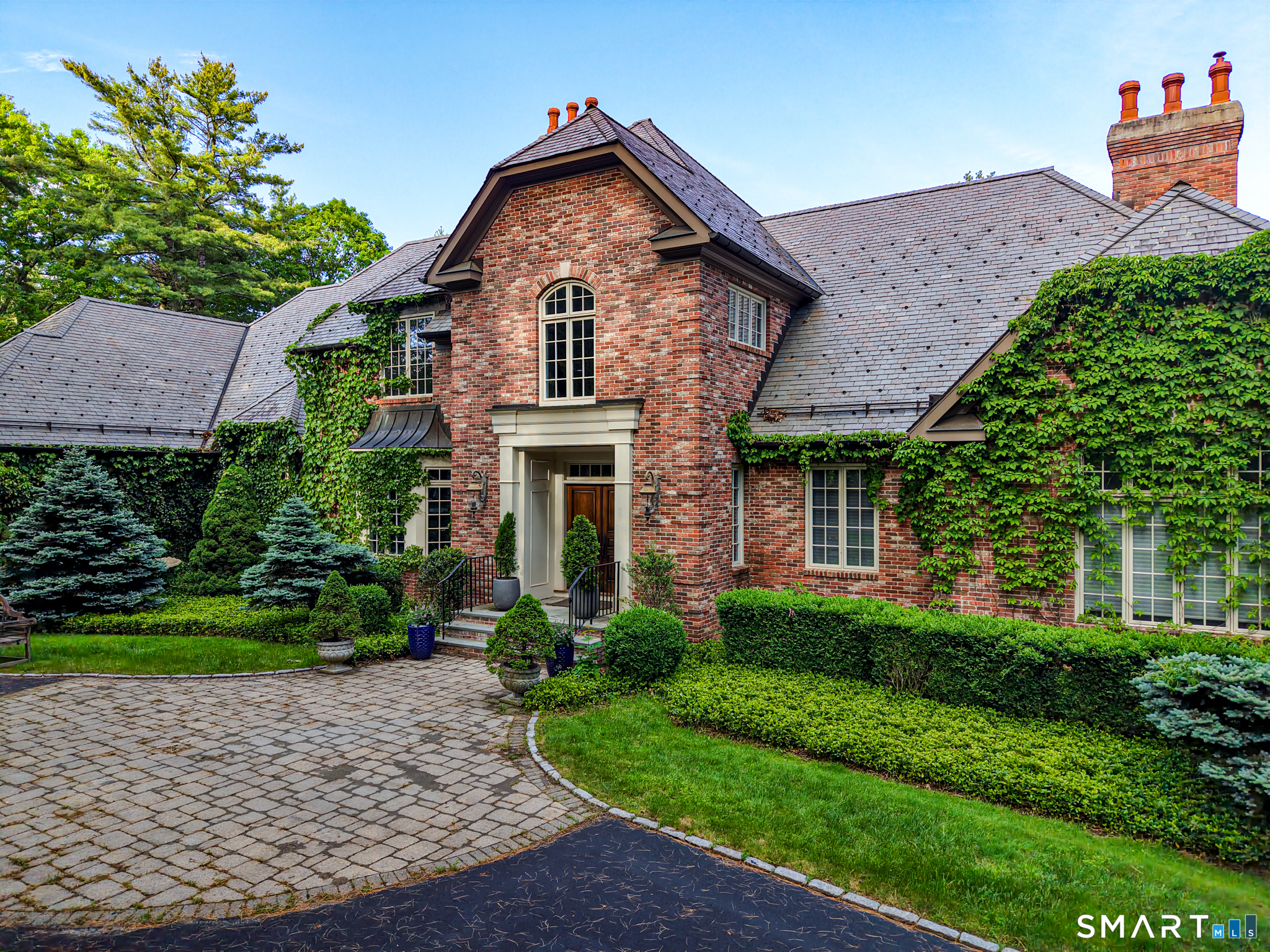 a front view of a house with a garden