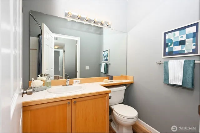 a bathroom with a toilet sink and mirror