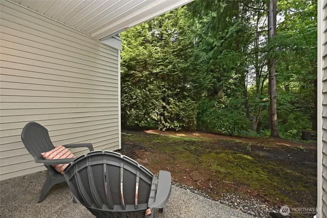a backyard of a house with table and chairs