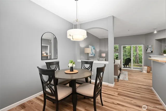 a view of a dining room with furniture window and wooden floor