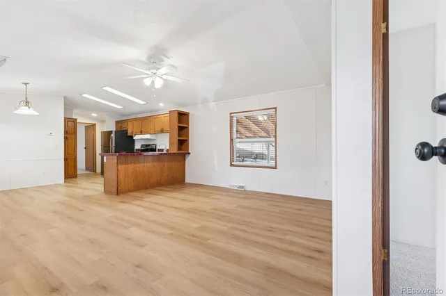 a view of a livingroom with furniture and a ceiling fan