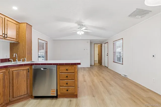 a kitchen with a stove a sink and a window