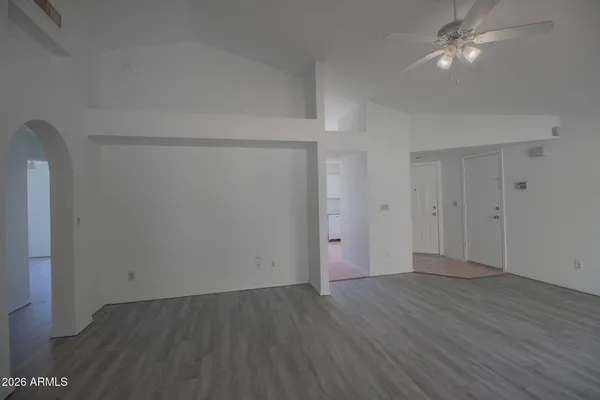 a view of an empty room with wooden floor