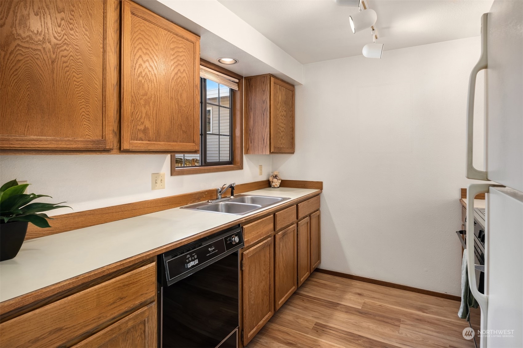 6049 5th Avenue Northwest Seattle, WA 98107 - Photo 11 of 22 a kitchen with a sink cabinets and wooden floor