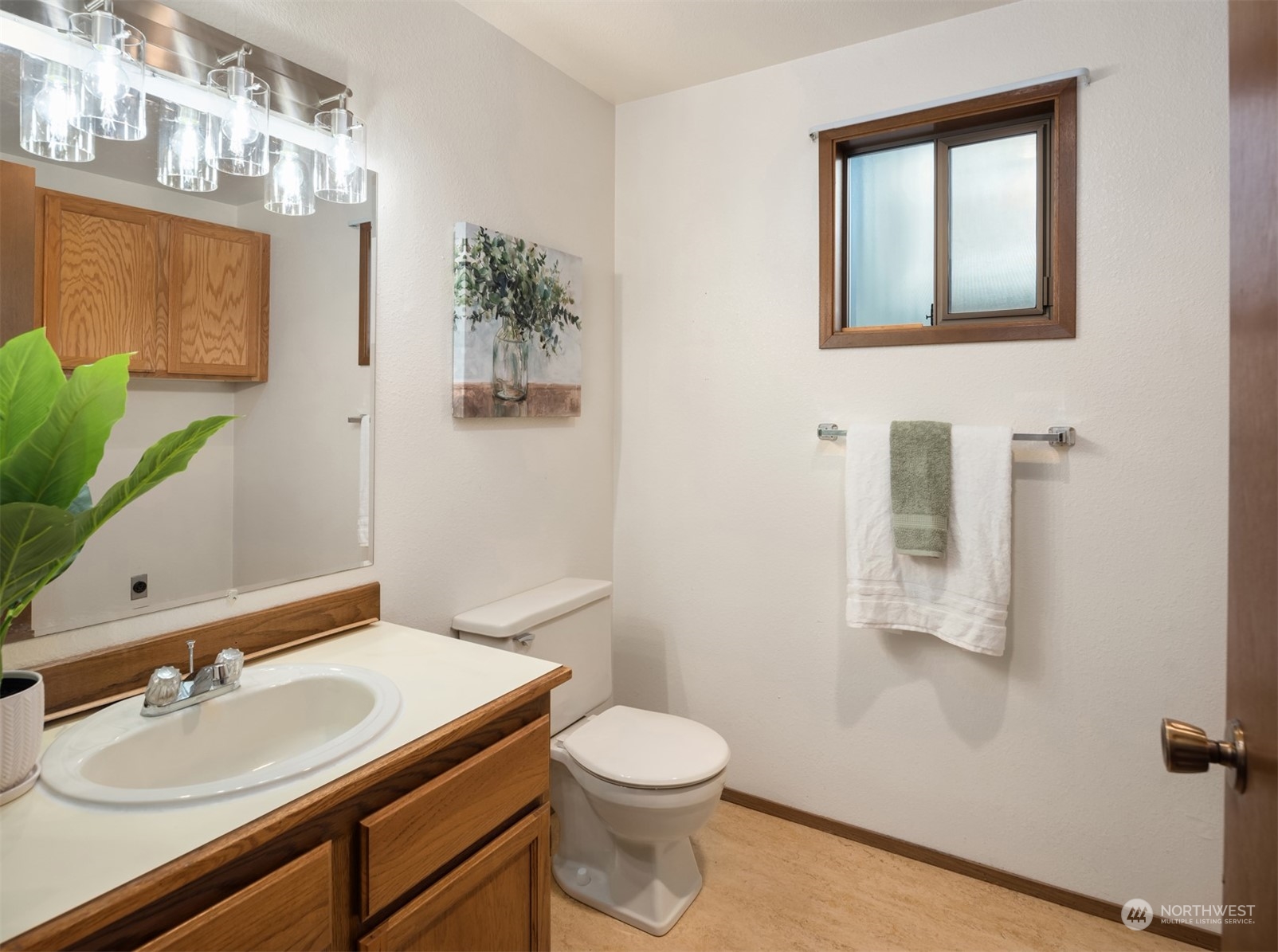 6049 5th Avenue Northwest Seattle, WA 98107 - Photo 17 of 22 a bathroom with a sink a toilet and mirror