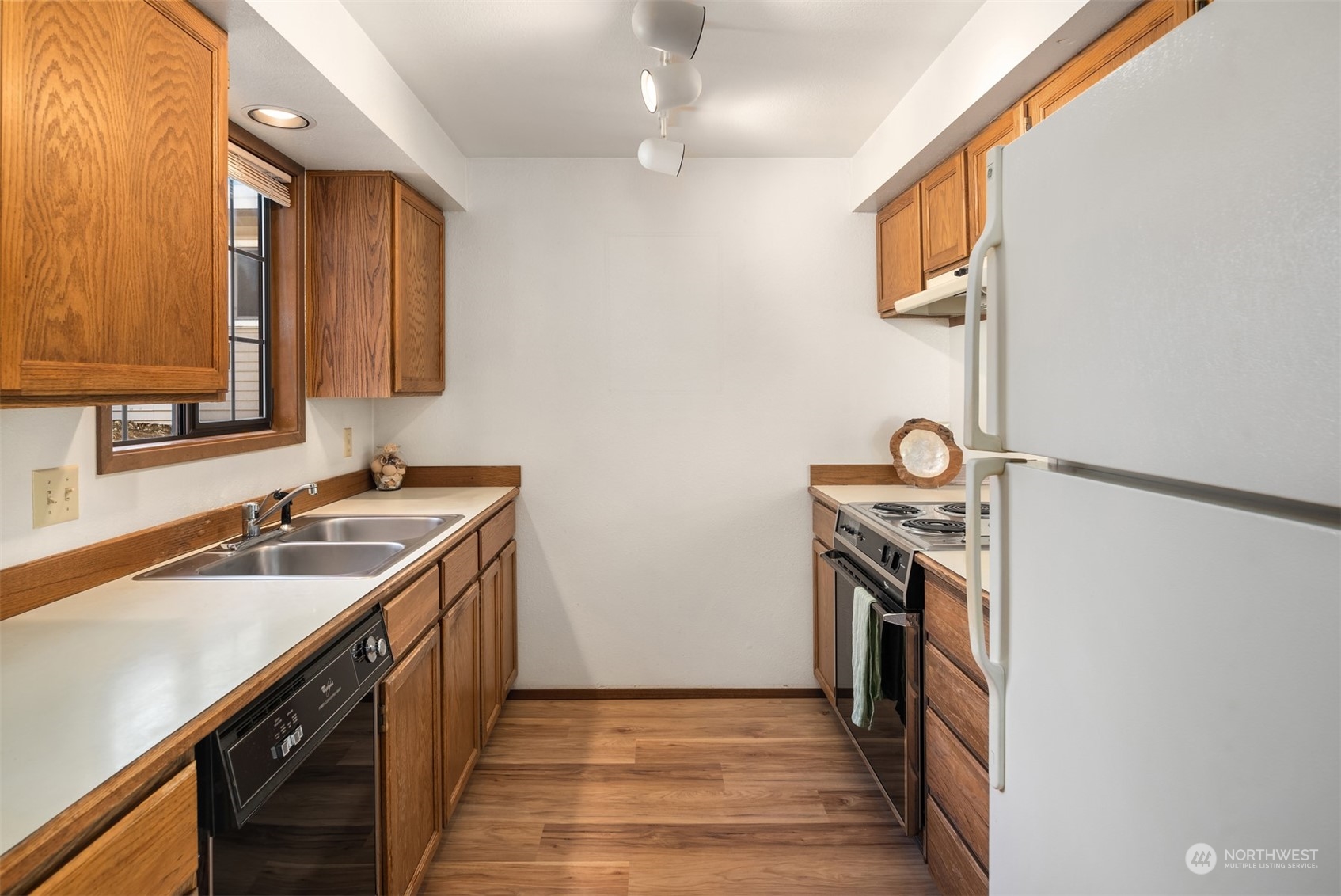 6049 5th Avenue Northwest Seattle, WA 98107 - Photo 10 of 22 a kitchen with a sink stove and refrigerator