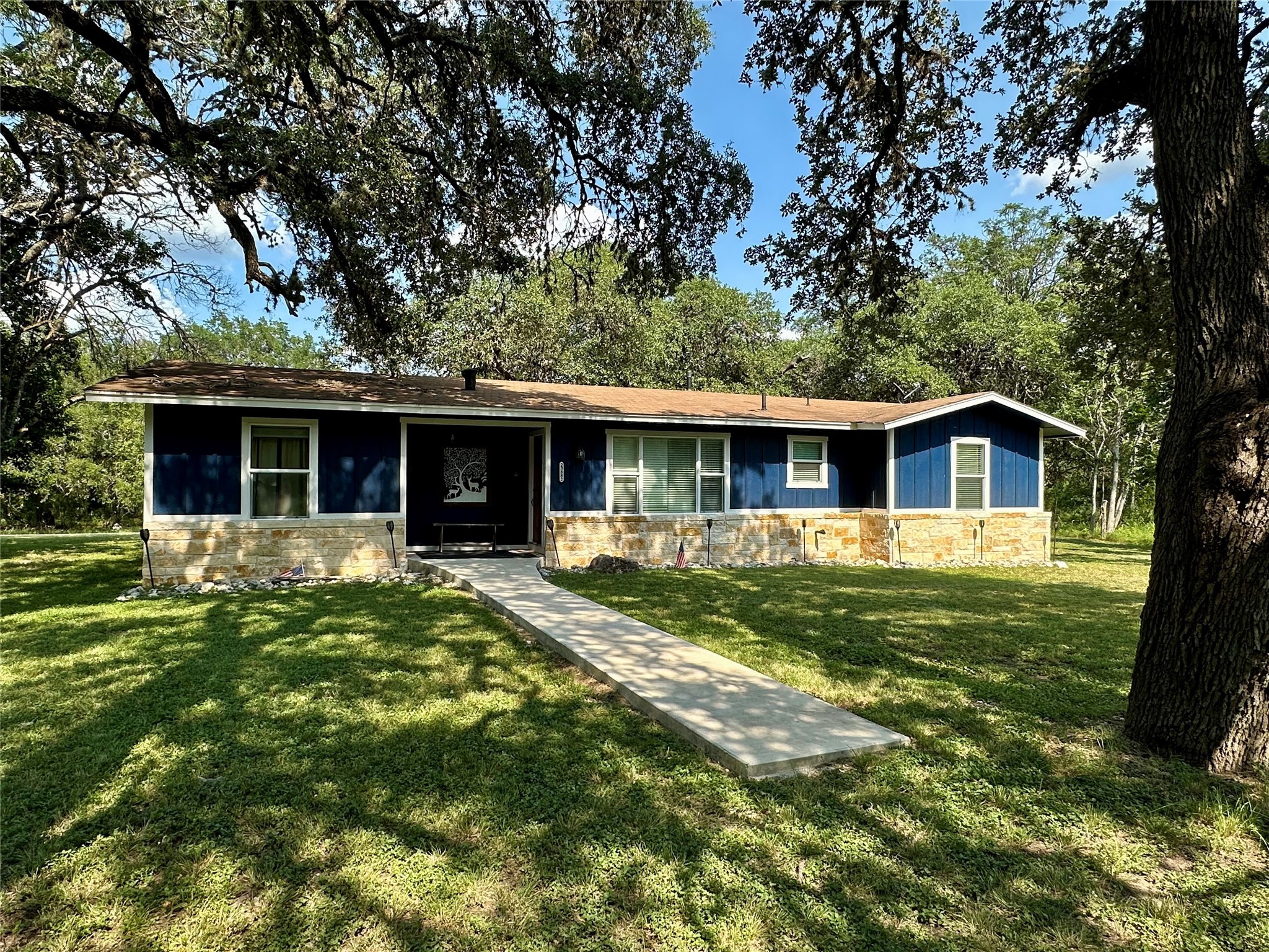a front view of house with yard and green space