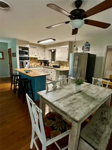 a living room with furniture and a dining table