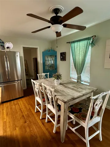 a large kitchen with a table and chairs in it