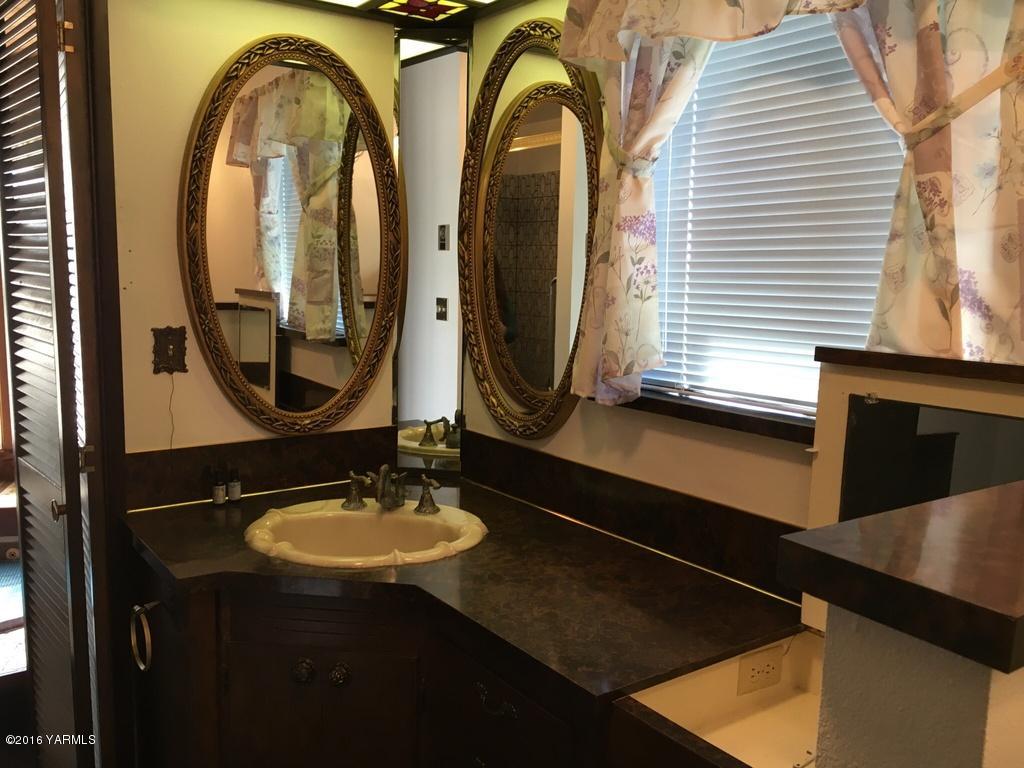2571 Ashue Road Wapato, WA 98951 - Photo 32 of 33 a bathroom with a sink and a mirror