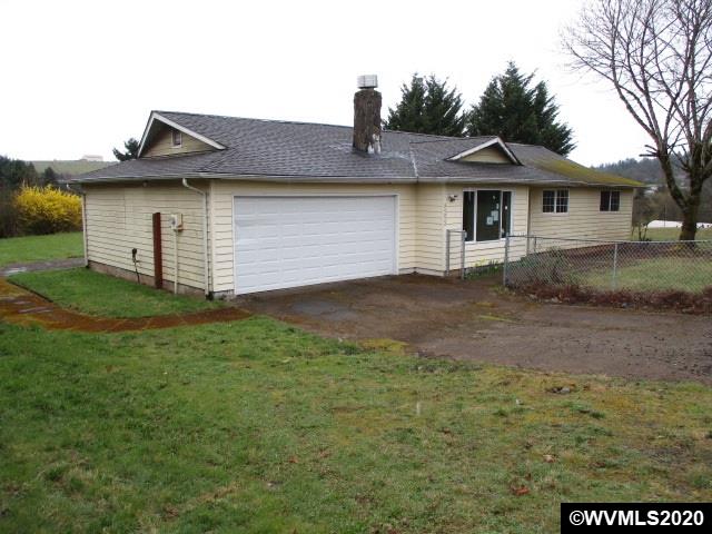 8292 Liberty Road South Salem, OR 97306 - Photo 2 of 29 a front view of a house with a yard and garage