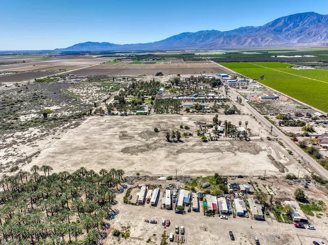 a view of swimming pool with outdoor seating and a garden