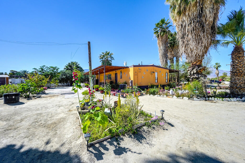 66350 Martinez Road Thermal, CA 92274 - Photo 51 of 68 a backyard of a house with a table and chairs under an umbrella