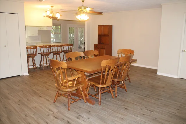 a view of a dining room with furniture and wooden floor