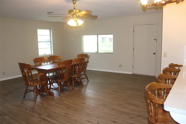 a view of a dining room with furniture and wooden floor