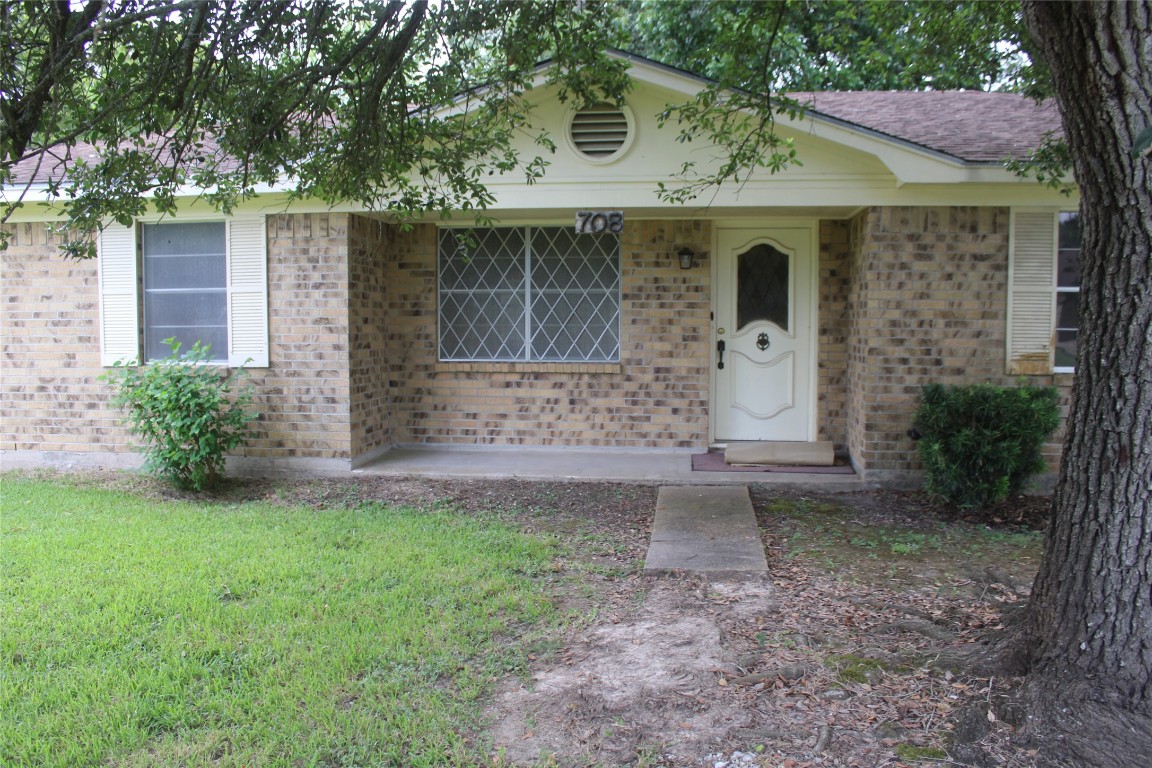 708 1st Street Winnie, TX 77665 - Photo 2 of 35 a front view of a house with garden