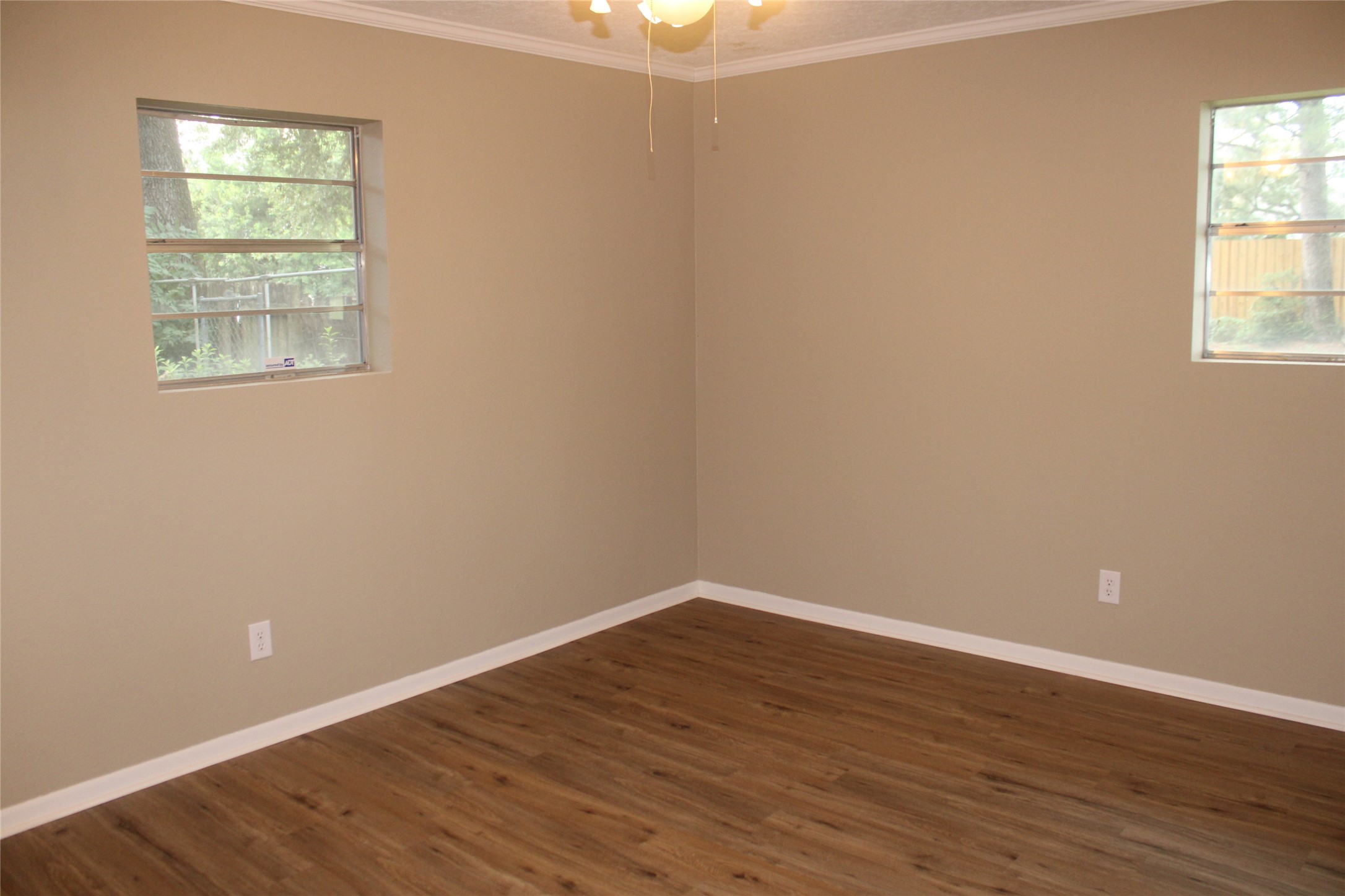 708 1st Street Winnie, TX 77665 - Photo 26 of 35 an empty room with wooden floor and windows
