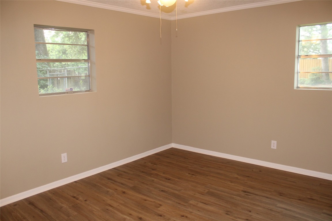 708 1st Street Winnie, TX 77665 - Photo 26 of 35 an empty room with wooden floor and windows