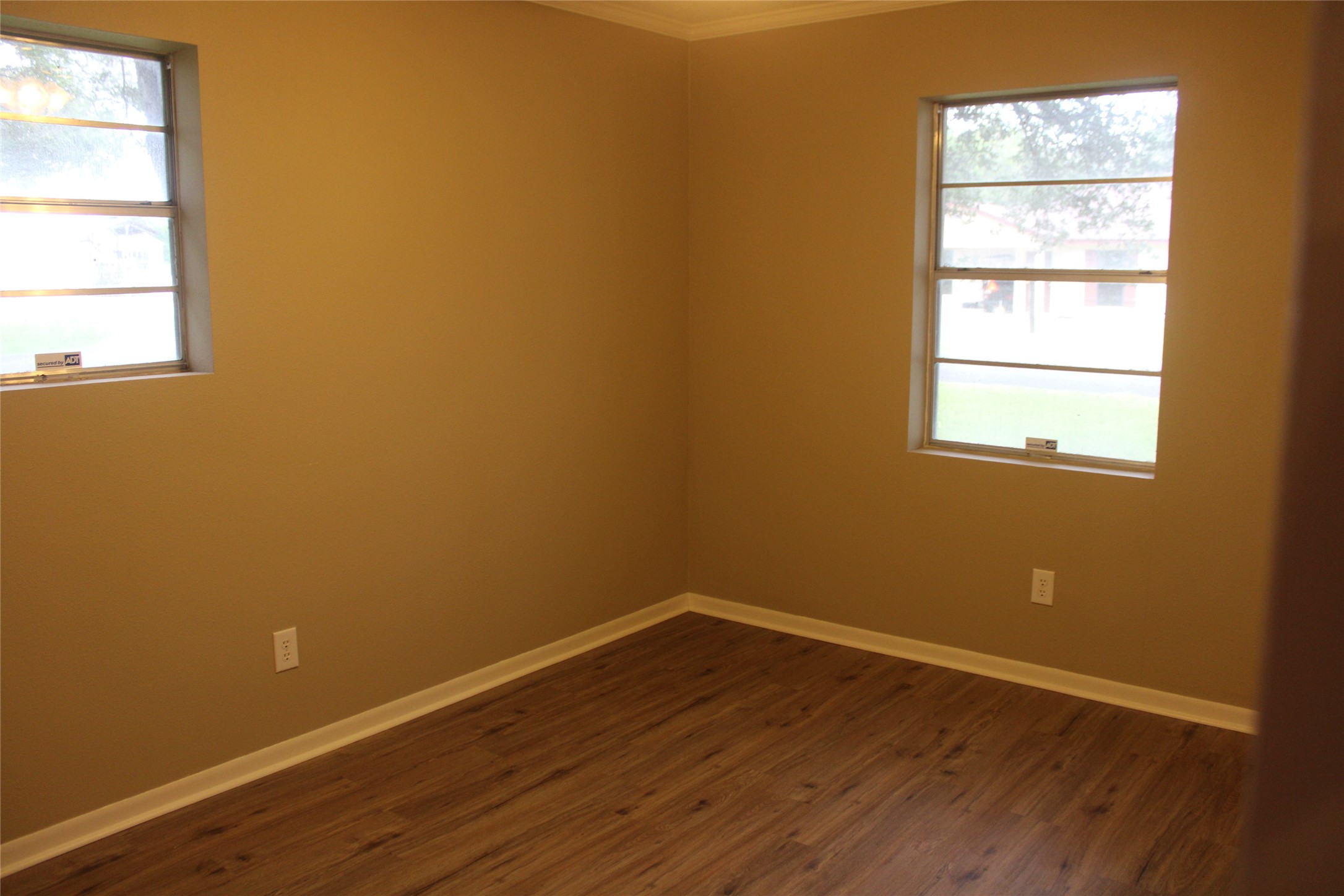 708 1st Street Winnie, TX 77665 - Photo 28 of 35 an empty room with wooden floor and windows