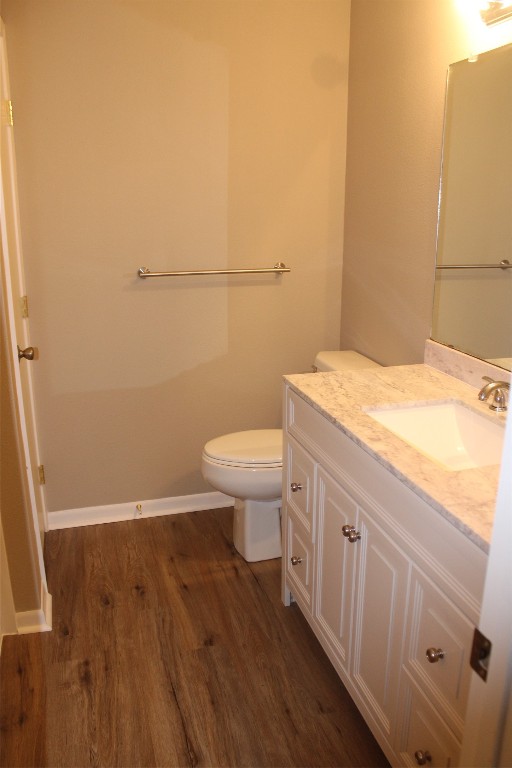 708 1st Street Winnie, TX 77665 - Photo 30 of 35 a bathroom with a sink a toilet and wooden floor