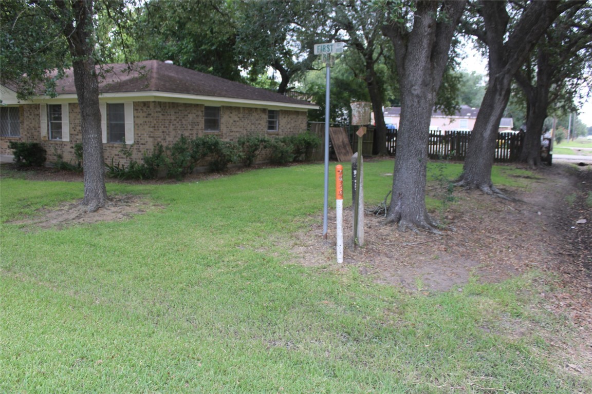 708 1st Street Winnie, TX 77665 - Photo 5 of 35 a view of a house with a backyard and a tree