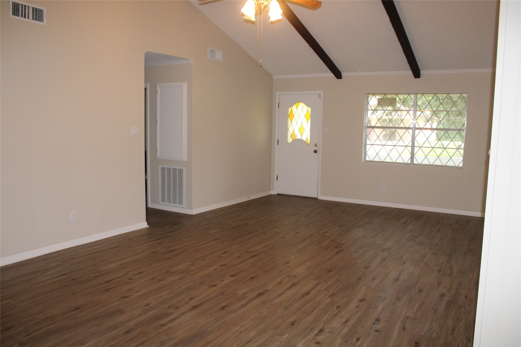 708 1st Street Winnie, TX 77665 - Photo 7 of 35 an empty room with wooden floor and windows