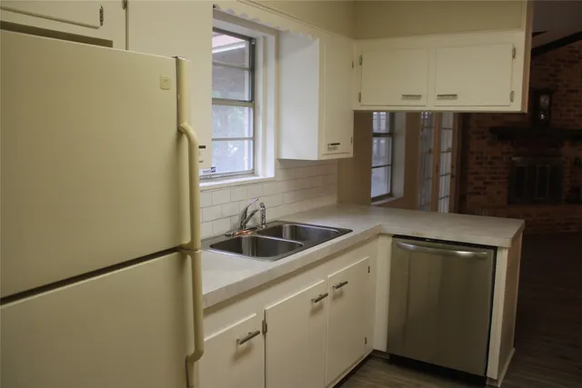 a kitchen with stainless steel appliances a sink and a refrigerator