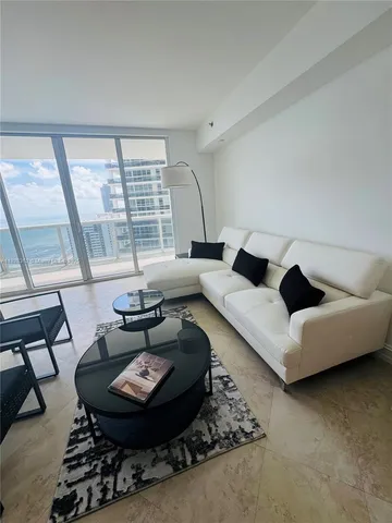 a view of a livingroom with furniture and lounge chair
